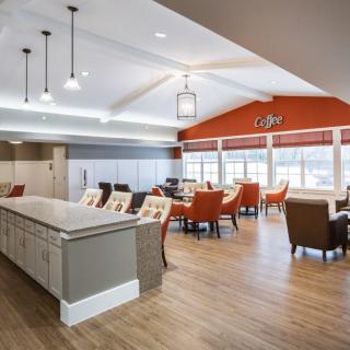 A modern dining and kitchen area with ample seating and natural light.