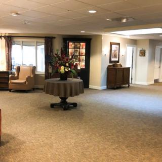 A spacious lobby area with comfortable seating and floral decorations.