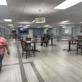 An empty dining area with tables and chairs, showcasing a modern interior design.