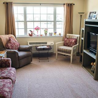 A cozy living room with comfortable seating and a large window.