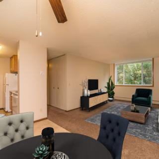 A cozy and modern living space featuring a dining area, comfortable seating, and a stylish design.