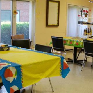 A colorful dining room with tables covered in bright tablecloths.