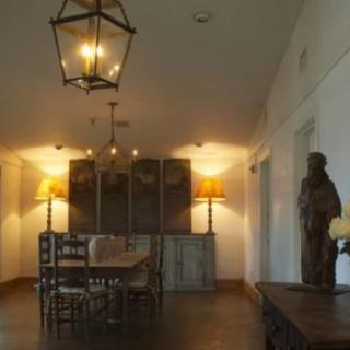 A warmly lit dining room with elegant decor and a central table.