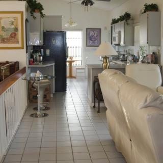 A cozy open-concept kitchen and living room area with modern furnishings and decor.