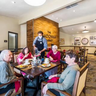 Seniors enjoying a meal together in a cozy restaurant setting.