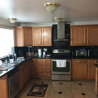 A modern kitchen with wooden cabinets and stainless steel appliances.