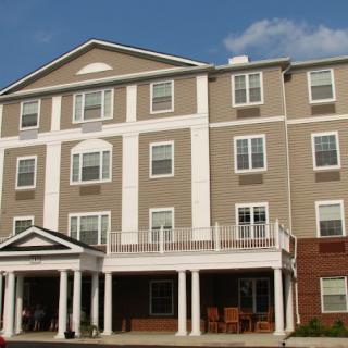 A modern multi-story hotel showcasing a welcoming facade with a porch.