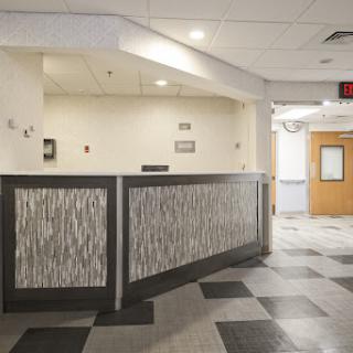 A modern reception area featuring a stylish counter and patterned flooring.