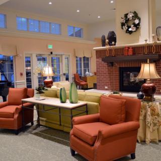A cozy living room with a fireplace, comfortable seating, and decorative elements.