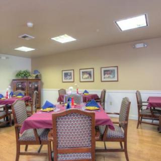 A neatly arranged dining room with tables set for a meal.