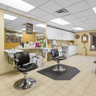 Interior of a clean and professional barbershop with styling chairs and mirrors.
