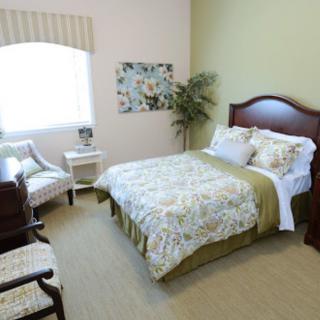 A cozy bedroom with a neatly made bed and elegant decor.