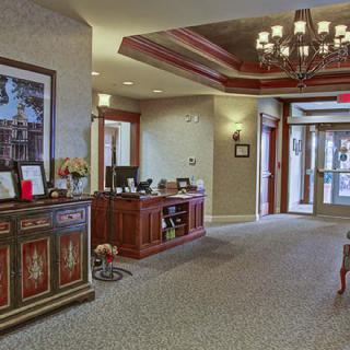 A welcoming lobby area with a wooden reception desk and elegant decor.