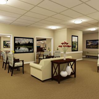 A cozy living room interior with a beige sofa, wall artwork, and warm lighting.