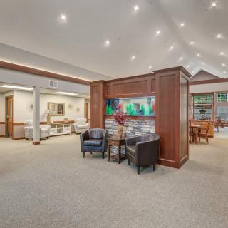A spacious and well-lit lobby with comfortable seating and wooden accents.