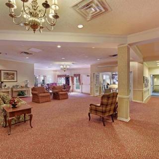 A spacious lobby area with elegant furnishings and a chandelier.