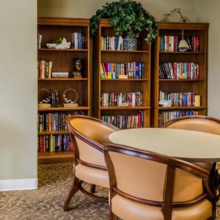 A cozy reading area with bookshelves and comfortable seating.