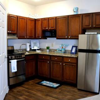 A modern kitchen with wooden cabinets and stainless steel appliances.