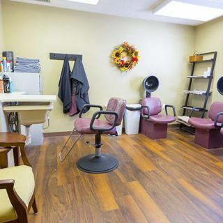 A cozy hair salon interior with stylish chairs and warm decor.