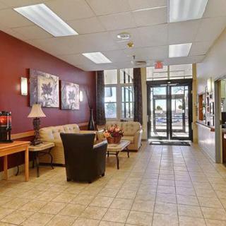 A cozy lobby area with comfortable seating and decorative artwork on the walls.