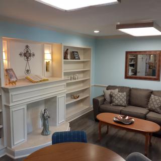 Cozy living room with a sofa, bookshelf, and decorative pieces.