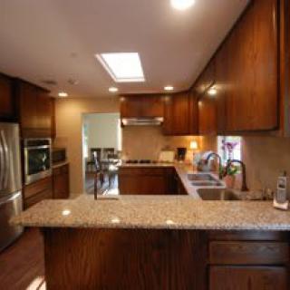 A cozy kitchen with wooden cabinets and modern appliances.