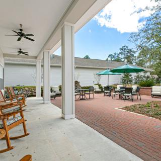 A spacious patio with outdoor seating and dining area under a clear sky.
