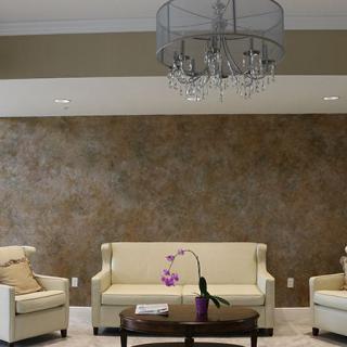 Elegant living room with cream sofas and a central chandelier.