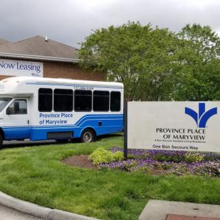 A shuttle bus parked outside Providence Place of Maryville, a healthcare facility.