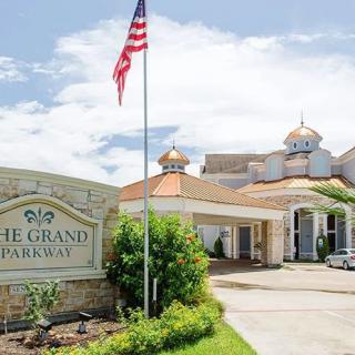 Entrance of a hotel with an American flag and a welcoming sign.