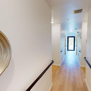 A bright, modern hallway featuring a minimalist design with decorative elements.