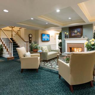 A cozy living room with comfortable seating and a fireplace.