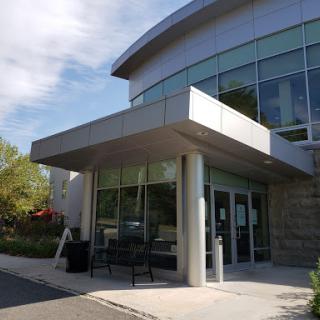 A modern architectural structure featuring a glass entrance.