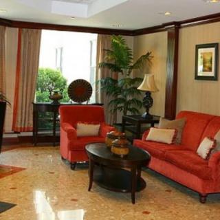 A cozy living room with red sofas and elegant decor.