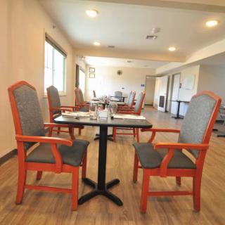 An empty dining room with neatly arranged tables and chairs.