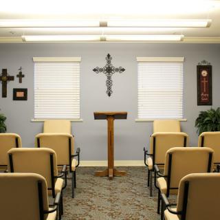 A small chapel with a podium and chairs arranged for a service.
