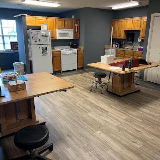 A spacious kitchen area featuring wooden cabinets, modern appliances, and a functional workspace.