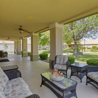 Spacious patio area with comfortable seating overlooking a lush garden.