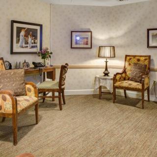 A cozy living room with vintage chairs and a warm ambiance.
