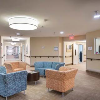 A modern waiting area with colorful seating and a well-lit corridor.