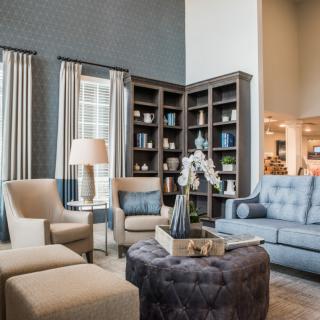 A stylish living room featuring comfortable seating, bookshelves, and tasteful decor.