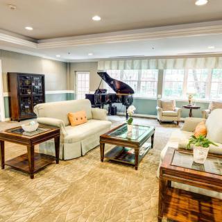 Spacious living room with elegant decor and a grand piano.