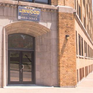 Entrance to a brick building with a sign above the door.