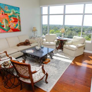 A bright and stylish living room with modern furniture and colorful artwork.