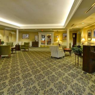 A spacious hotel lobby with elegant seating and soft lighting.