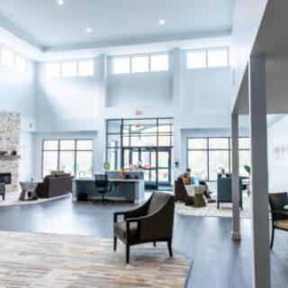 A modern and spacious lobby with ample seating and large windows.