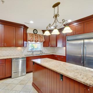 Modern kitchen with wood cabinets and a granite island.