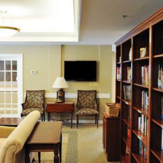 A cozy library corner with bookshelves and a seating area.