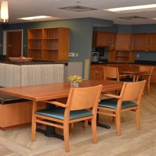 A modern kitchen and dining area with wooden furniture and cabinets.