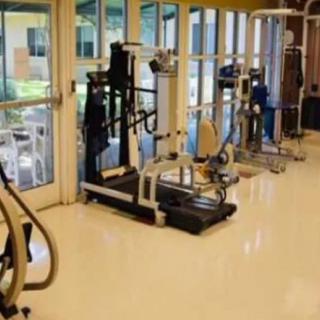 A fitness center with various exercise machines, including treadmills and other workout equipment.